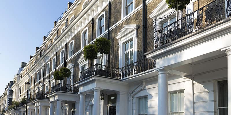 A picture of British townhouses with the words conveyancing overlaid.